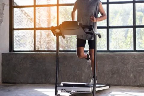 Young men exercise on an automatic treadmill Stock Photos