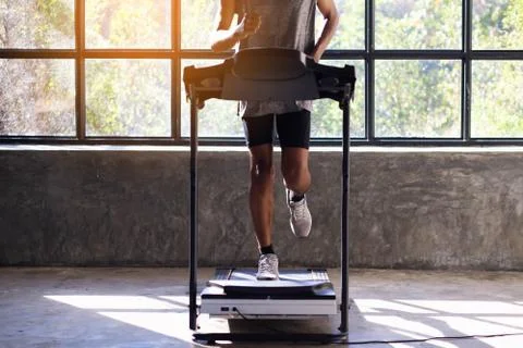 Young men exercise on an automatic treadmill Stock Photos