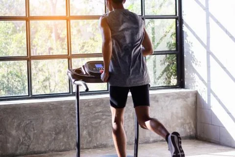 Young men exercise on an automatic treadmill Stock Photos