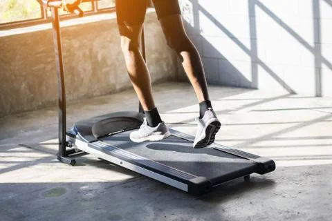Young men exercise on an automatic treadmill Stock Photos