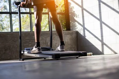 Young men exercise on an automatic treadmill Stock Photos