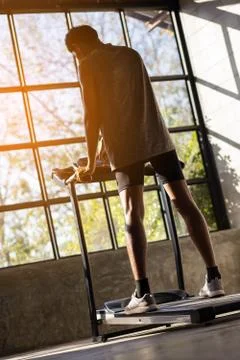 Young men exercise on an automatic treadmill Stock Photos