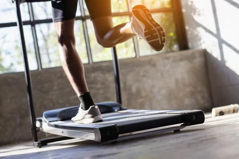 Young men exercise on an automatic treadmill Stock Photos