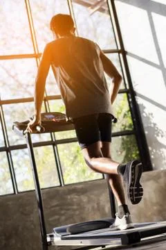 Young men exercise on an automatic treadmill Stock Photos