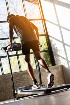 Young men exercise on an automatic treadmill Stock Photos