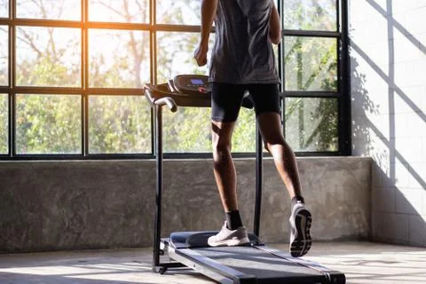 Young men exercise on an automatic treadmill Stock Photos