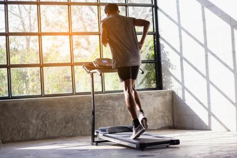 Young men exercise on an automatic treadmill Stock Photos