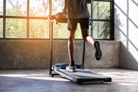 Young men exercise on an automatic treadmill Stock Photos