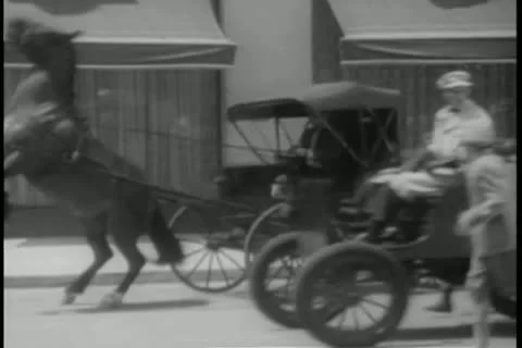 Young men following car down street Stock Footage 11349568