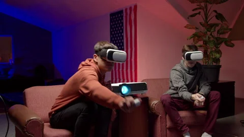 Young men in headsets playing virtual videogame together Stock Footage 147398422