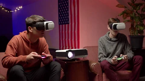 Young men in headsets playing virtual videogame together Stock Footage 147398837