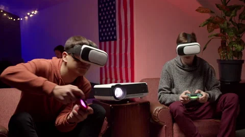 Young men in headsets playing virtual videogame together Stock Footage 147398987