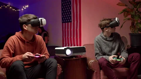 Young men in headsets playing virtual videogame together Stock Footage 147399200