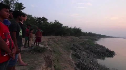 Young men look out over the Ganges River in India Stock Footage 65726411
