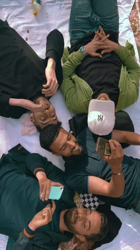 Young men lying on the ground enjoying a relaxing weekend in a forest. Video stock 309781481