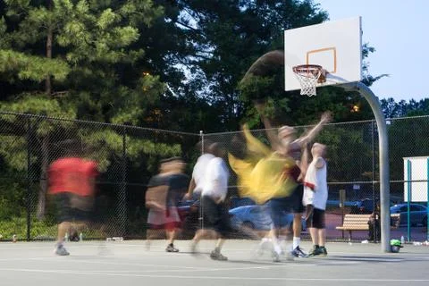 Young Men Motion Blur Playing Outdoor Pickup Basketball Game Stock Photos