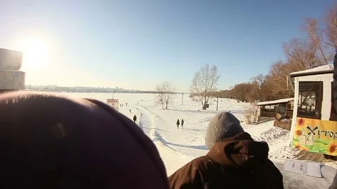 Young men move down from the snow slides Stock Footage 69788744