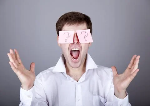 Young men with notes on eyes. Stock Photos