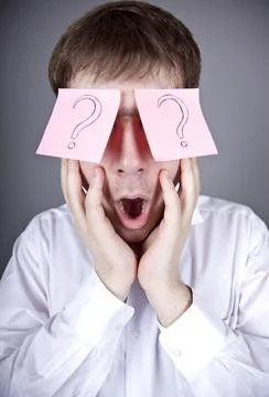 Young men with notes on eyes. Stock Photos