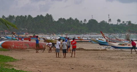 Young Men Play Cricket Between Fishing Boats On Sri Lankan Beach Stock Footage 345638318