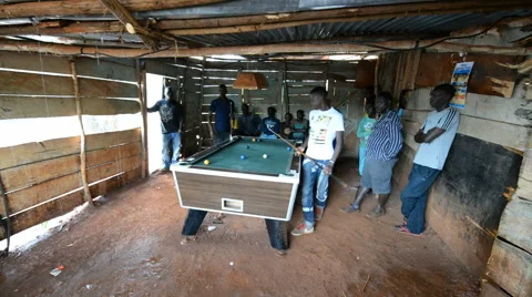 A young men playing billiards in the hut in the Jinja, Uganda. Stock Footage 59796115