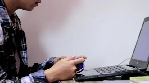 Young men playing game using stick in laptop Stock Footage 171193366