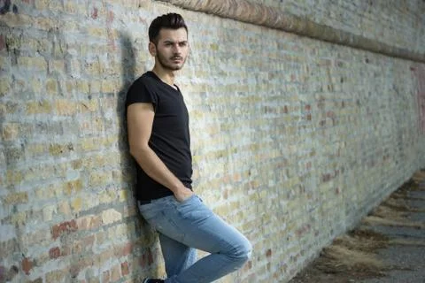 Young men posing, sitting on old stairs. Stock Photos