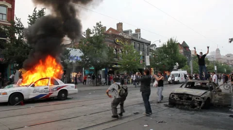 Young men riot during protest with burning police car Video stock 38923522
