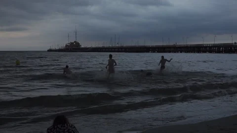 Young men runing into sea Stock Footage 146986869