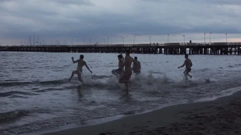Young men runing into sea Stock Footage 150402650