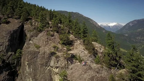  Young Men Sitting On Cliff Edge With Beautiful Mountain Background Stock-Footage 78657305
