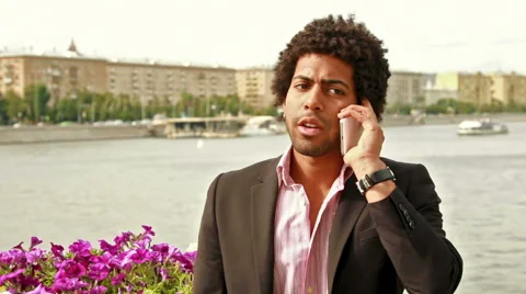 Young men talking on the cell phone Stock Footage 52009533