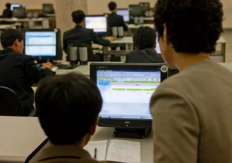 Young men using intranet on a computer in the Grand people's study house, Pyo 스톡 사진