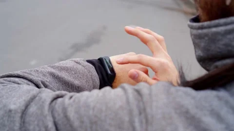 Young men using a touch sport smartwatch in the city while is preparing to ru Stock Footage 157823040