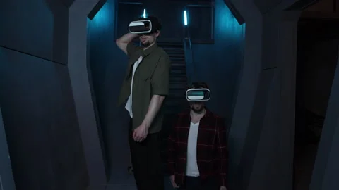 Young men walking along a corridor while using AR technology Stock Footage 239402980