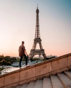 Young men watching Eiffel tower in Paris. guy tourist visiting Paris France by Stock Photos