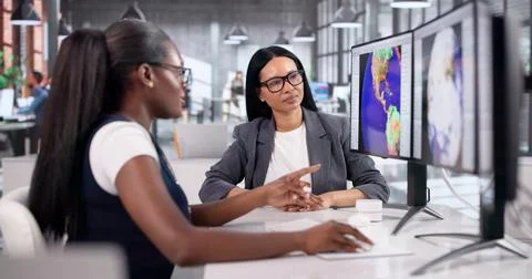 Young Meteorologist Analyzes Storm Data On Computer During Team Discussion Stock Photos