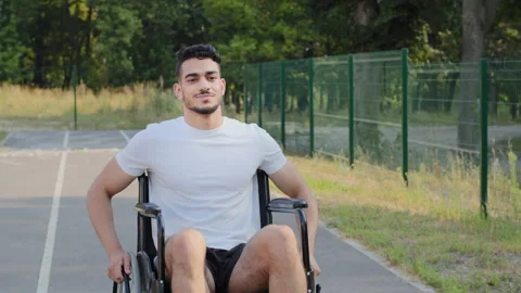 Young Middle eastern Arabic man having disability rides wheelchair on summer 스톡 동영상 167133388