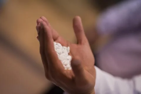 Young Middle Eastern doctors and medical technician holding white tablets in a Stock Photos