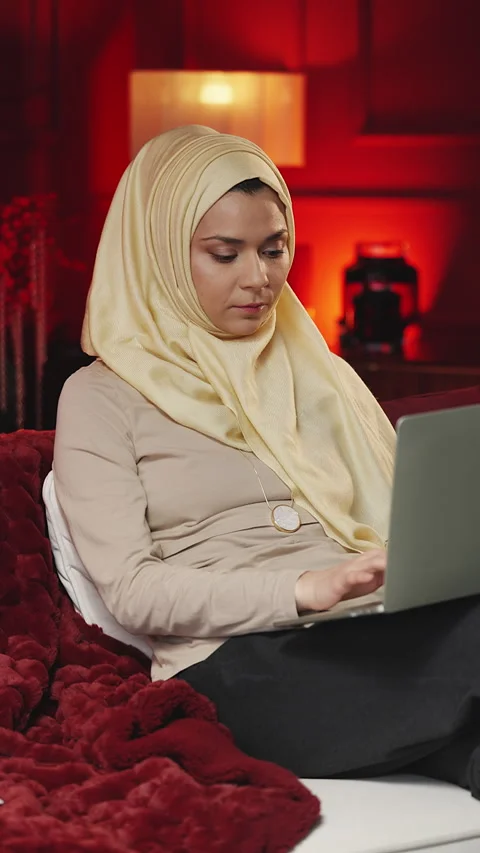 Young Middle Eastern freelancer typing on laptop while working from home 動画素材 347166104
