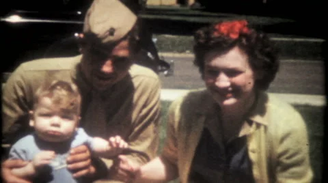 Young military family pose for the camera 1940s vintage film home movie 2068 Stock Footage