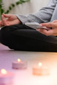 Young millennial blonde woman doing yoga exercise watching tutorial lesson on Stock Photos