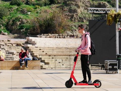 Young millennial on an electric scooter Stock Photos