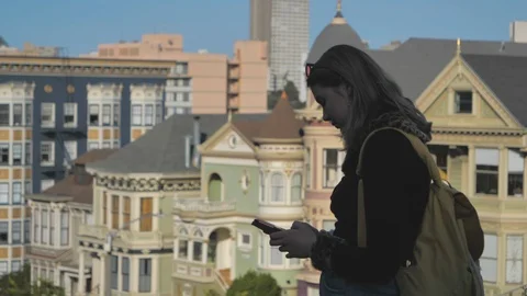 Young millennial girl using mobile smartphone social media San Francisco City Stock Footage 121601029
