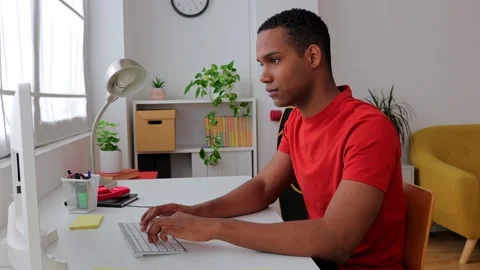 Young millennial student boy working on laptop computer sitting on desk at home Stock Footage 271296142