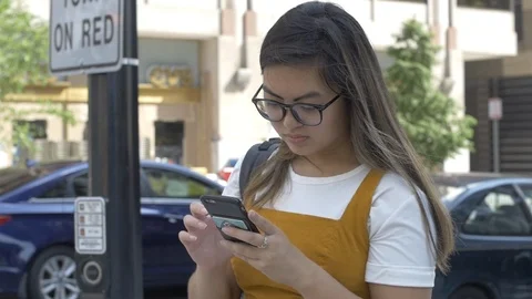 Young Millennial texts in City Stock Footage 114708226