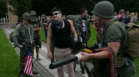 Young millennials making fun out of American US army, make up for zombie walk Stock Footage 68703113