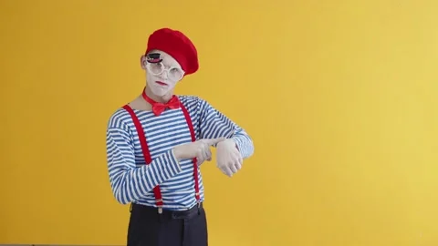 A young mime guy plays a funny performance, points his finger at an imaginary Stock Footage 226370034