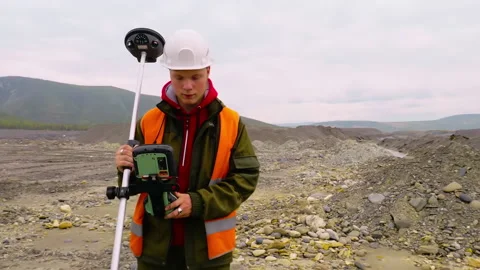 Young Mining Industry Surveyor Worker Checks GPS Tool Attached To Prism Pole Stock Footage 187066750