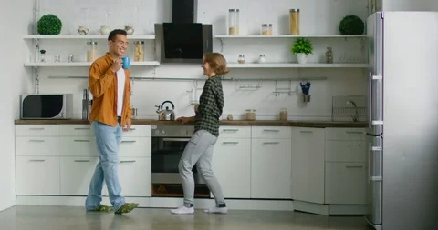 Young mixed couple talking and hugging in kitchen Stock Footage 113637039
